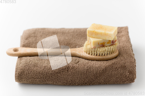 Image of crafted soap bars, natural brush and bath towel