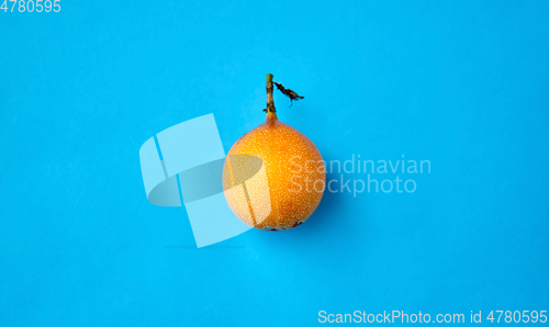 Image of ripe granadilla on blue background