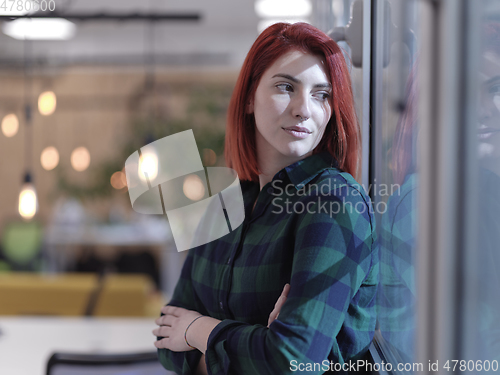 Image of redhead business woman portrait in creative modern coworking startup open space office