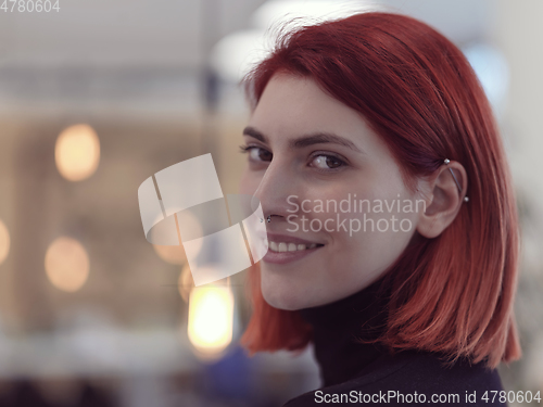 Image of redhead business woman portrait in creative modern coworking startup open space office