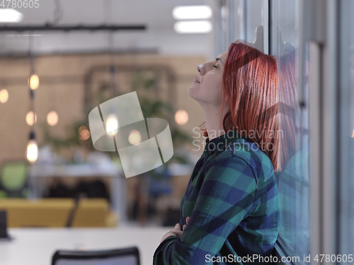 Image of redhead business woman portrait in creative modern coworking startup open space office