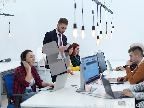 Image of creative business people group as freelancers in modern coworking open space office