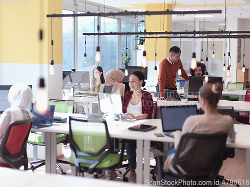 Image of creative business people group as freelancers in modern coworking open space office