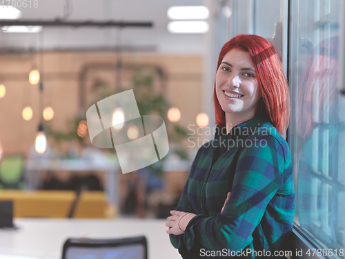 Image of redhead business woman portrait in creative modern coworking startup open space office