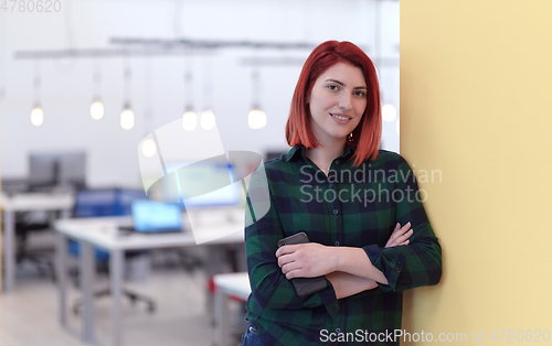 Image of redhead business woman portrait in creative modern coworking startup open space office