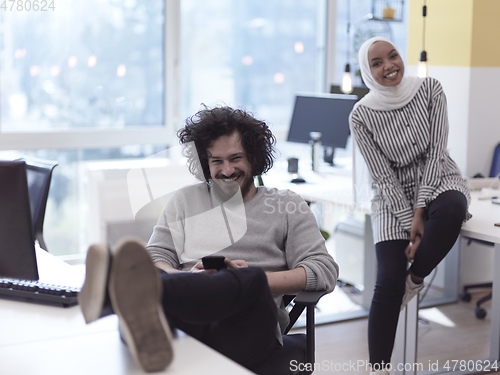 Image of relaxed businessman working at modern office