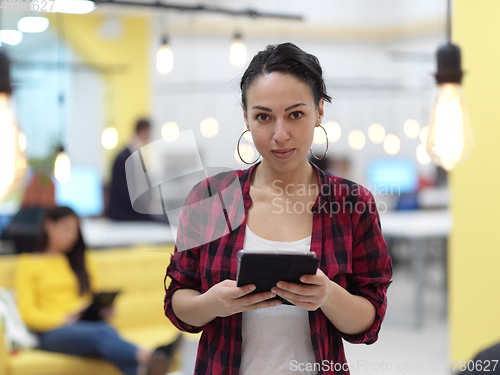 Image of business woman at work in creative modern coworking startup open space office