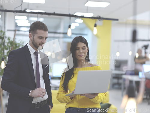 Image of business team working together on project at modern coworking office