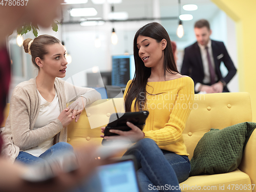 Image of female friends discussion about project at moder coworking office