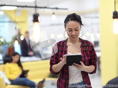 Image of business woman at work in creative modern coworking startup open space office