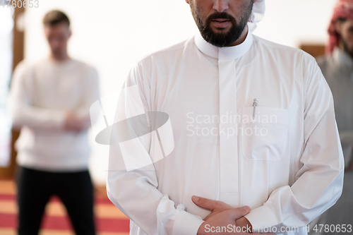 Image of group of muslim people praying namaz in mosque.