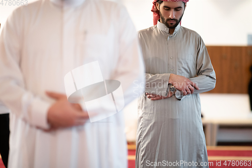 Image of group of muslim people praying namaz in mosque.