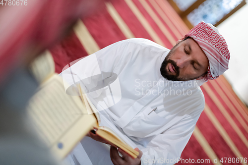 Image of two muslim people in mosque reading quran together concept of islamic education