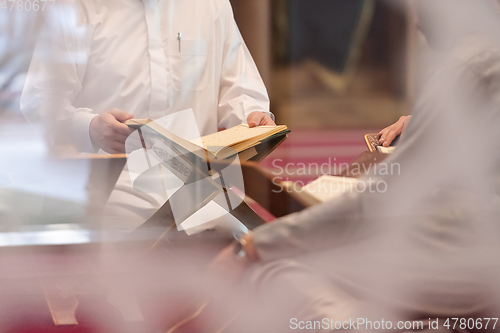 Image of muslim people in mosque reading quran together