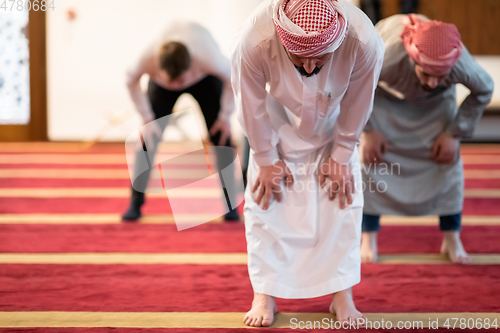 Image of group of muslim people praying namaz in mosque.