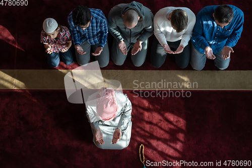 Image of group of muslim people praying namaz in mosque.