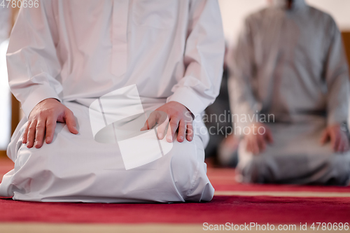 Image of group of muslim people praying namaz in mosque.