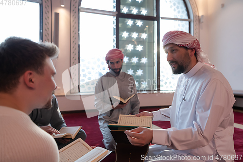 Image of muslim people in mosque reading quran together