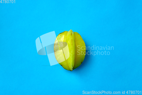 Image of ripe carambola or star fruit on blue background