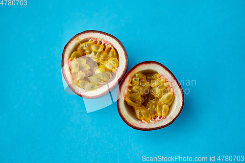 Image of cut passion fruit on blue background