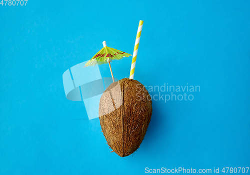 Image of coconut drink with straw and cocktail umbrella