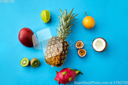 Image of pineapple with other fruits on blue background