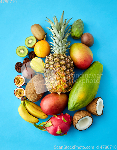 Image of many different exotic fruits on blue background