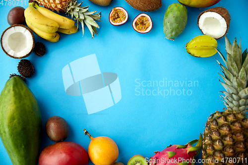 Image of different exotic fruits on blue background