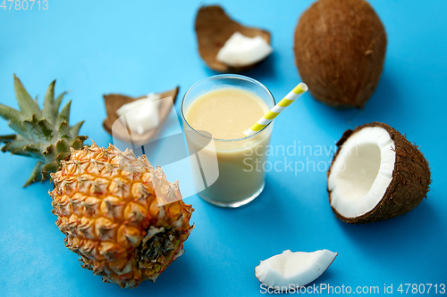 Image of pineapple, coconut and drink with paper straw