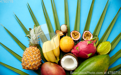 Image of different exotic fruits on blue background