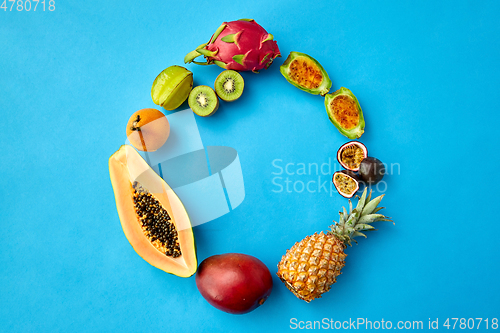 Image of different exotic fruits on blue background