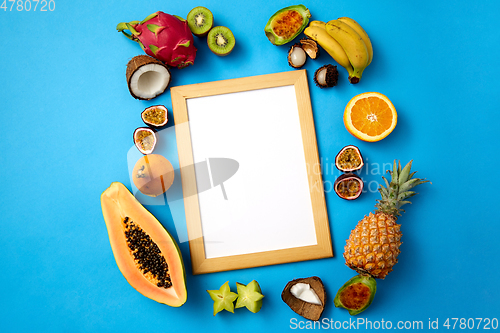 Image of fruits around wooden frame with white background