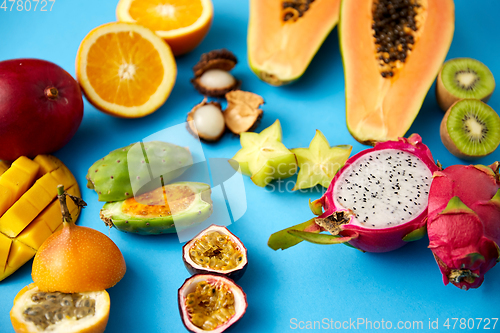 Image of different exotic fruits on blue background