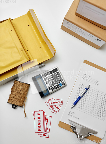 Image of calculator, clipboard and envelopes at post office