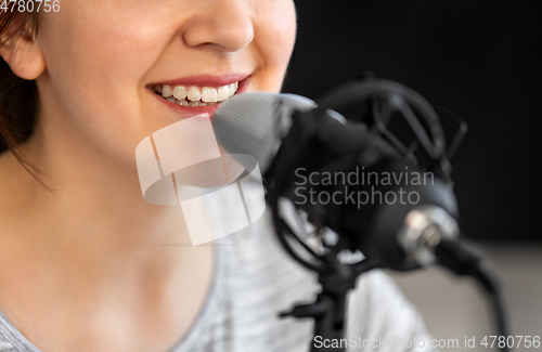 Image of close up of woman talking to microphone