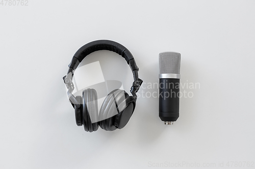 Image of headphones and microphone on white background