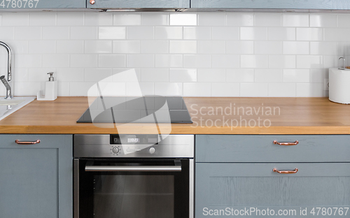 Image of modern home kitchen interior with oven and hob