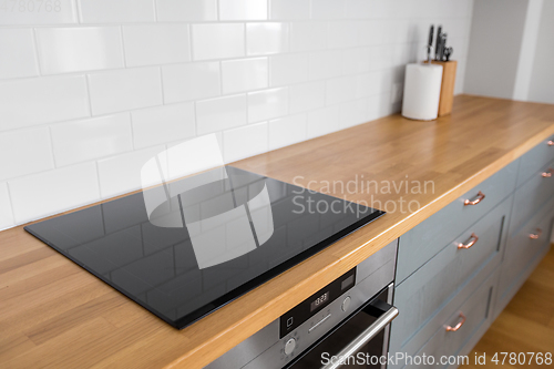 Image of modern home kitchen interior with oven and hob