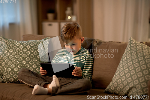 Image of happy little boy with tablet computer at home