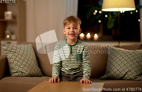 Image of happy smiling little boy at home at night