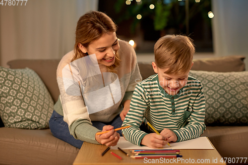 Image of mother and son with pencils drawing at home