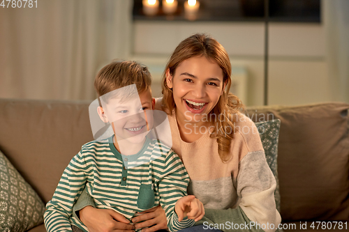 Image of happy laughing mother with her son at home