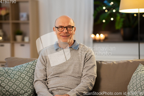 Image of happy smiling senior man in glasses at home