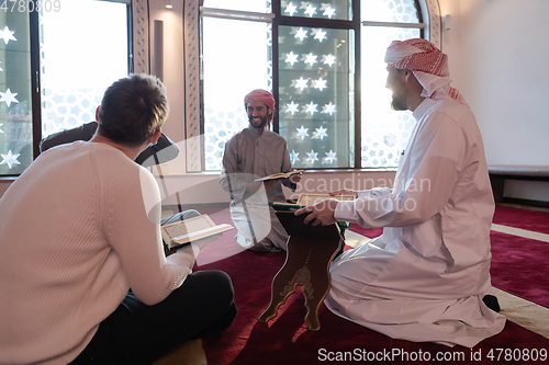 Image of muslim people in mosque reading quran together