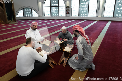 Image of muslim people in mosque reading quran together