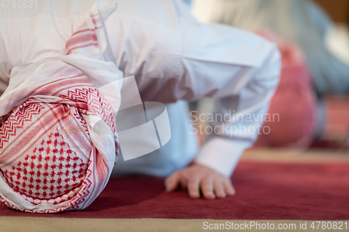 Image of group of muslim people praying namaz in mosque.