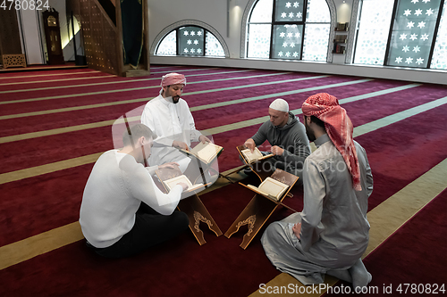 Image of muslim people in mosque reading quran together