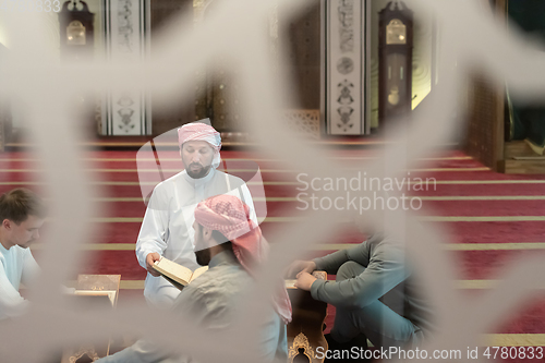 Image of muslim people in mosque reading quran together