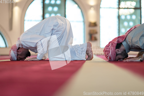 Image of group of muslim people praying namaz in mosque.