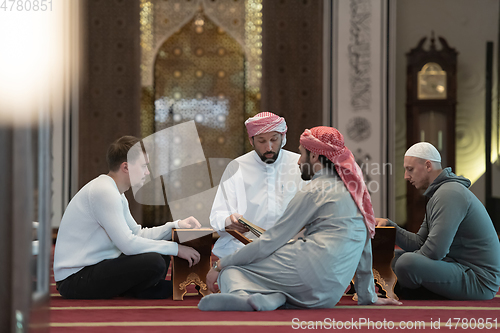 Image of muslim people in mosque reading quran together